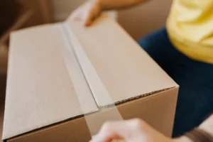 Image of a person opening a parcel for the blog How Can Integrating 3PL Solutions Elevate Your Business's Logistics Operations